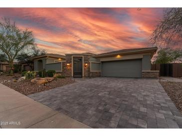 Charming home exterior boasting a paved driveway, desert landscaping and attached two car garage at 3045 W Feather Sound Dr, Phoenix, AZ 85086