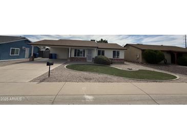 Charming single-story home featuring a well-maintained front yard and a covered carport at 7007 S 45Th Pl, Phoenix, AZ 85042