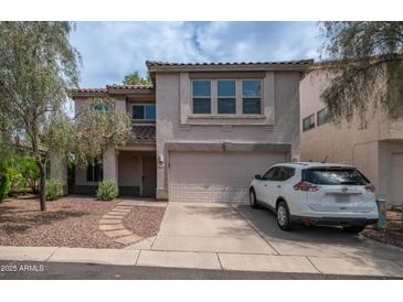 Two-story home with a two car garage, desert landscaping, and a white SUV parked on the driveway at 726 E Rose Marie Ln, Phoenix, AZ 85022