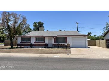 Charming single-Gathering home featuring well-maintained landscaping, a red brick accent, and an attached one car garage at 8502 N 26Th Ave, Phoenix, AZ 85021