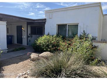 Charming home featuring low maintenance landscaping and red flowering shrubs in the front yard at 1718 E Gaylon Dr, Tempe, AZ 85282
