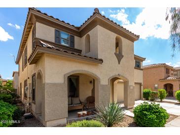 Charming two-story home featuring a welcoming front porch and desert landscaping at 18525 W Valerie Dr, Surprise, AZ 85374