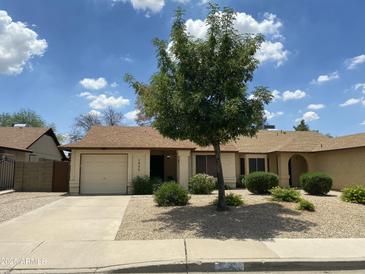 Charming single-story home with a well-manicured, low maintenance front yard and private two car garage at 2845 E Irwin Ave, Mesa, AZ 85204