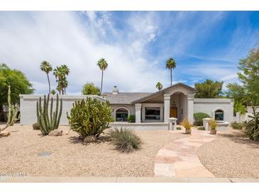 Beautiful desert landscaping frames this charming home with a stone pathway to the front door at 5438 E Lupine Ave, Scottsdale, AZ 85254