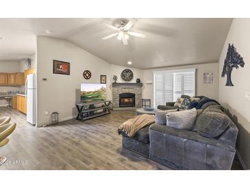 Comfortable living room features a stone fireplace and wood-look flooring at 8111 E 5Th Ave, Mesa, AZ 85208
