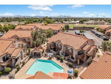 Aerial view showcases a refreshing community pool surrounded by well-maintained buildings and landscaping at 839 S Westwood -- # 154, Mesa, AZ 85210