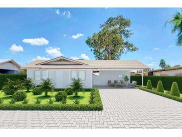 Charming single-story home with a well-manicured front yard and a long driveway at 875 E Flint St, Chandler, AZ 85225