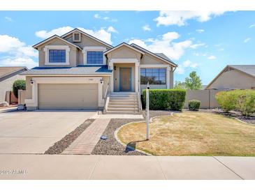 Charming two-story home with a well-maintained lawn and inviting curb appeal on a sunny day at 1903 E Jasper Dr, Chandler, AZ 85225