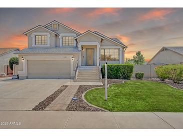 Charming two-story home with a well-manicured lawn, inviting entrance, and a two-car garage at 1903 E Jasper Dr, Chandler, AZ 85225