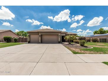 Charming single-story home with a tile roof, three-car garage, and well-maintained landscaping at 20826 S Hadrian Way, Queen Creek, AZ 85142