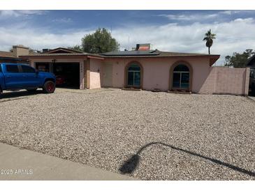 Charming single-story home with a low-maintenance rock yard and arched windows at 2840 W Marlette Ave, Phoenix, AZ 85017