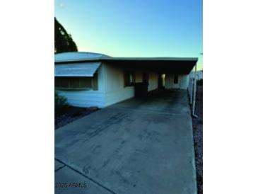Charming single-story home featuring a covered parking and well-maintained landscape at 3104 E Broadway Rd # 295, Mesa, AZ 85204
