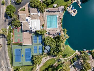 Stunning aerial view of the lake community, showcasing pool, tennis courts, and boat docks for an active lifestyle at 5200 S Lakeshore Dr # 120, Tempe, AZ 85283