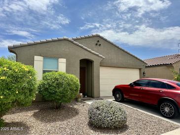 Charming home featuring a desert landscape, covered entry, neutral color scheme and a two car garage at 9825 W Trumbull Rd, Tolleson, AZ 85353