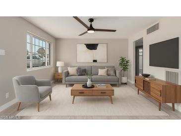Relaxing living room featuring a comfortable sofa, chair, and modern decor for a cozy ambiance at 1010 W 5Th Pl, Mesa, AZ 85201