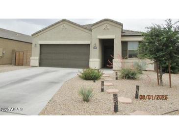Charming single-story home with desert landscaping, walkway lights, and a two-car garage at 1246 E Thomas Dr, Casa Grande, AZ 85122