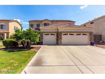 Stunning two-story home featuring a spacious three-car garage and manicured landscaping at 13005 W Vista Paseo Dr, Litchfield Park, AZ 85340