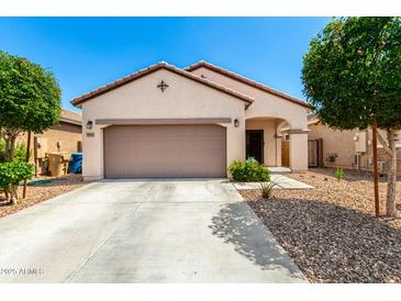 Charming single-story home with a well-maintained front yard and attached two-car garage at 19847 W Monroe St, Buckeye, AZ 85326