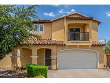 Inviting two-story home with a charming front porch and a two-car garage at 2046 E Paradise Ln, Phoenix, AZ 85022