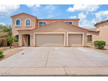 Charming home featuring a three-car garage and arched windows at 2286 E Mohave Ln, Apache Junction, AZ 85119