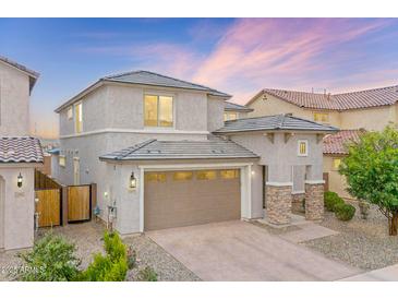 Charming two-story home with a two-car garage and desert landscaping, perfect for curb appeal at 23010 E Pummelos Rd, Queen Creek, AZ 85142