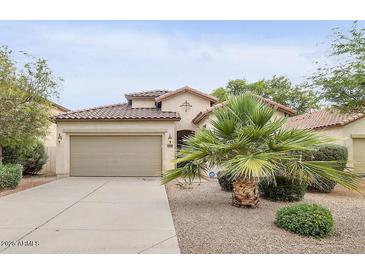 Charming single-story home featuring a well-manicured front yard and a two-car garage at 36199 W Prado St, Maricopa, AZ 85138