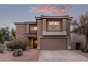 Charming two-story home featuring a tile roof and a two car garage at 7500 E Deer Valley Rd # 157, Scottsdale, AZ 85255