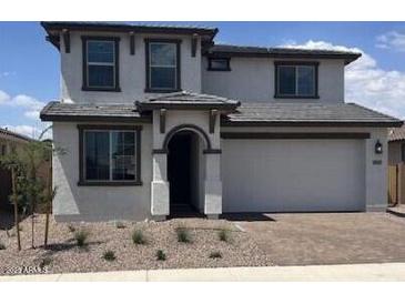 Beautiful two-story home with a two car garage, neutral color palette, and well maintained front yard at 10860 E Tiburon Ave, Mesa, AZ 85212