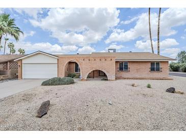 Charming single-story home featuring a well-maintained brick facade and a desert-landscaped front yard at 11631 N 30Th St, Phoenix, AZ 85028