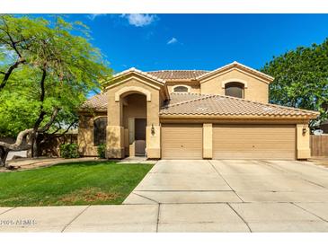 Inviting two-story home with a well-manicured lawn and a three-car garage at 1268 N Pine St, Gilbert, AZ 85233