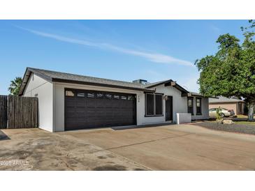 Charming single story home with a two car garage and well-maintained landscaping at 156 E Jasmine St, Mesa, AZ 85201