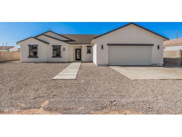 Charming single-story home with a well-maintained yard and attached two-car garage, perfect for Gathering living at 5499 E Red Bird Ln, San Tan Valley, AZ 85140