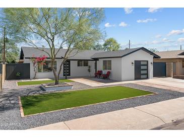 Charming single-story home with modern updates and a well-manicured front yard at 8732 E Arlington Rd, Scottsdale, AZ 85250
