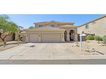 Two-story home boasts a three-car garage and desert landscaping at 10448 E Conieson Rd, Scottsdale, AZ 85255