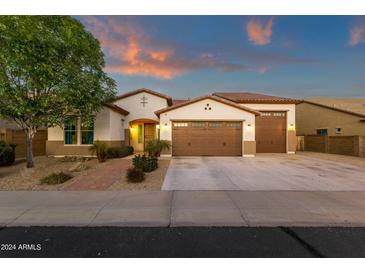 Charming single-story home with a well-manicured yard and a spacious three-car garage at 16105 N 183Rd Dr, Surprise, AZ 85388