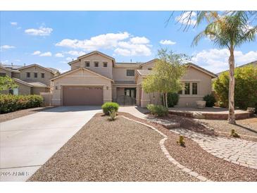 Beautiful two-story home featuring a well-manicured lawn, desert landscaping, and an attached two-car garage at 22737 N Sunset Dr, Maricopa, AZ 85139