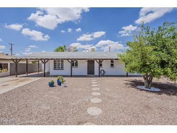 Charming single-story home with desert landscaping and covered parking at 3202 W Glenrosa Ave, Phoenix, AZ 85017