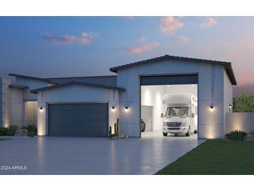 Modern home showcasing large RV garage, desert landscaping, and sleek architectural details at 7591 W Gelding Dr, Peoria, AZ 85381