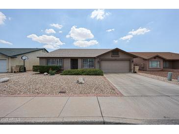 Charming single-story home featuring a low-maintenance desert landscape and a two-car garage at 8943 W Sierra Vista Dr, Glendale, AZ 85305