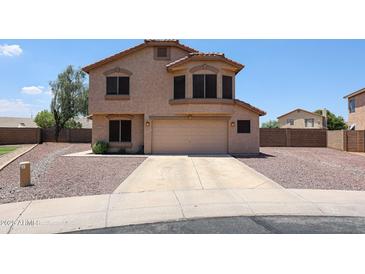 Two-story stucco home featuring a neutral color palette, desert landscaping, and an attached two-car garage at 9243 W Palmer Dr, Peoria, AZ 85345