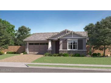 Charming single-story home featuring a neutral palette, paired garage and manicured lawn at 1516 W Ridge Rd, Apache Junction, AZ 85120