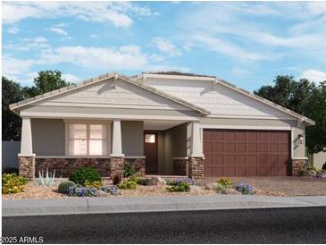 Charming single-story home featuring a two-car garage, landscaped front yard, and stone veneer accents at 15918 W El Cortez Pl, Surprise, AZ 85387