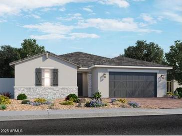 Charming single-story home with stone accents, manicured landscaping, and a two-car garage at 15951 W El Cortez Pl, Surprise, AZ 85387