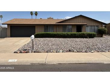 Charming single-story home featuring a well-maintained front yard with desert landscaping and a two-car garage at 1714 W Villa Rita Dr, Phoenix, AZ 85023