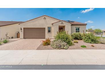 Charming single-story home with low maintenance desert landscaping and brick driveway, presenting inviting curb appeal at 17886 W Brookwood Dr, Goodyear, AZ 85338