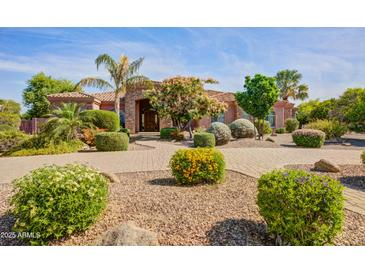 Inviting front yard with lush landscaping and a charming walkway leading to the entrance of this beautiful single-story home at 21384 E Excelsior Ave, Queen Creek, AZ 85142