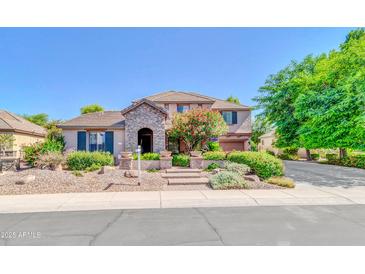 Charming two-story home featuring a stone-accented facade, landscaped yard, and inviting entrance at 2383 E Zion Way, Chandler, AZ 85249