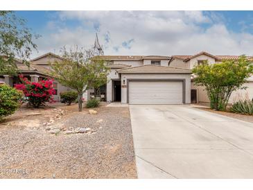 Charming two-story home with a desert-landscaped front yard, long driveway, and neutral color palette at 41678 N Salix Dr, San Tan Valley, AZ 85140