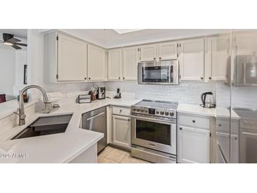 Well-lit kitchen featuring stainless steel appliances and ample white cabinetry at 9450 E Becker Ln # 1046, Scottsdale, AZ 85260