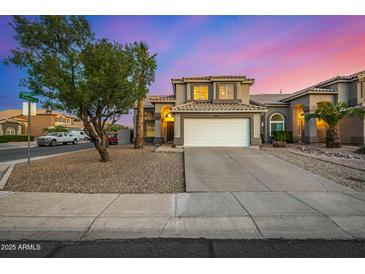Charming two-story home showcasing a wide driveway, desert landscaping, and neutral tones at 1655 W Stanford Ave, Gilbert, AZ 85233